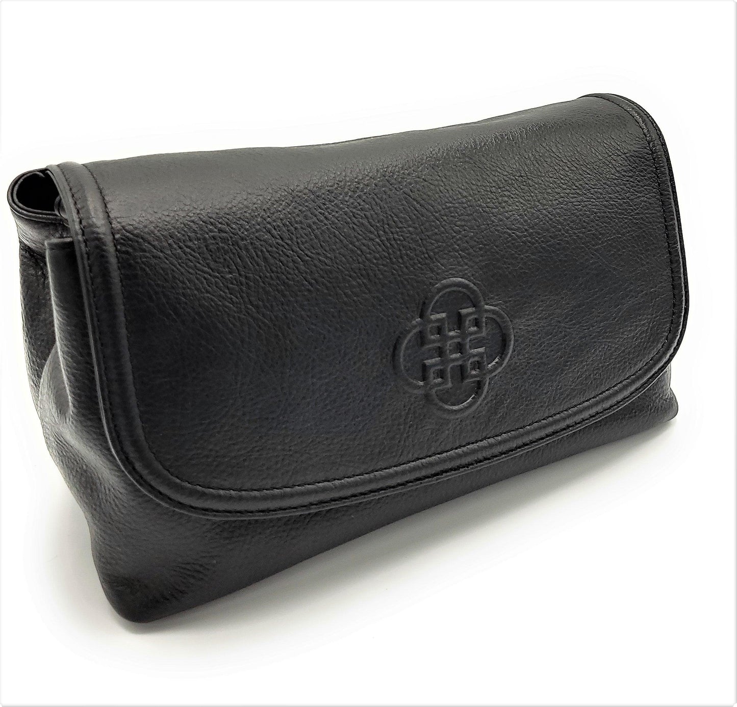 Black leather clutch bag with a central embossed design on a white background