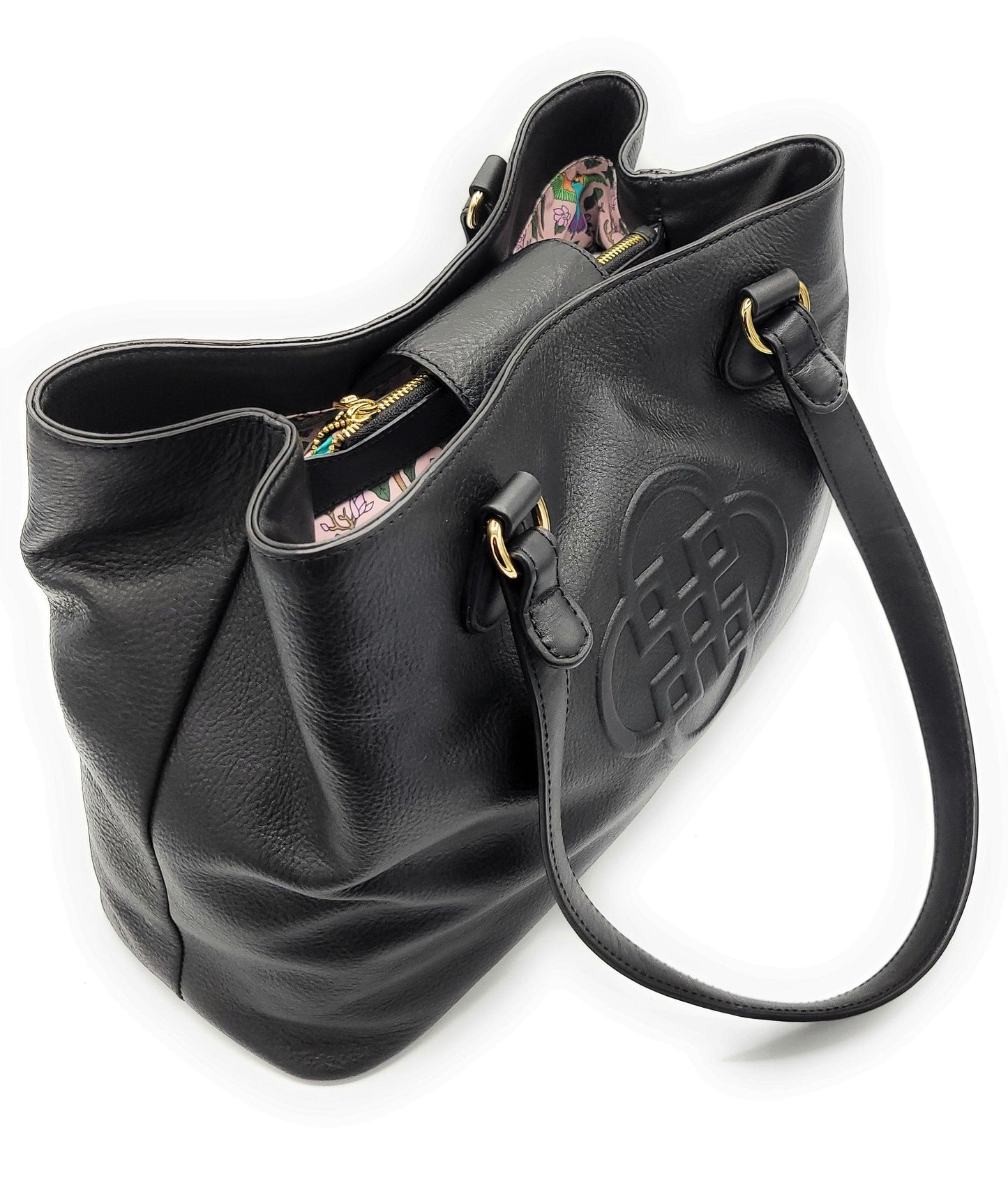 Black leather handbag with floral interior on a white background