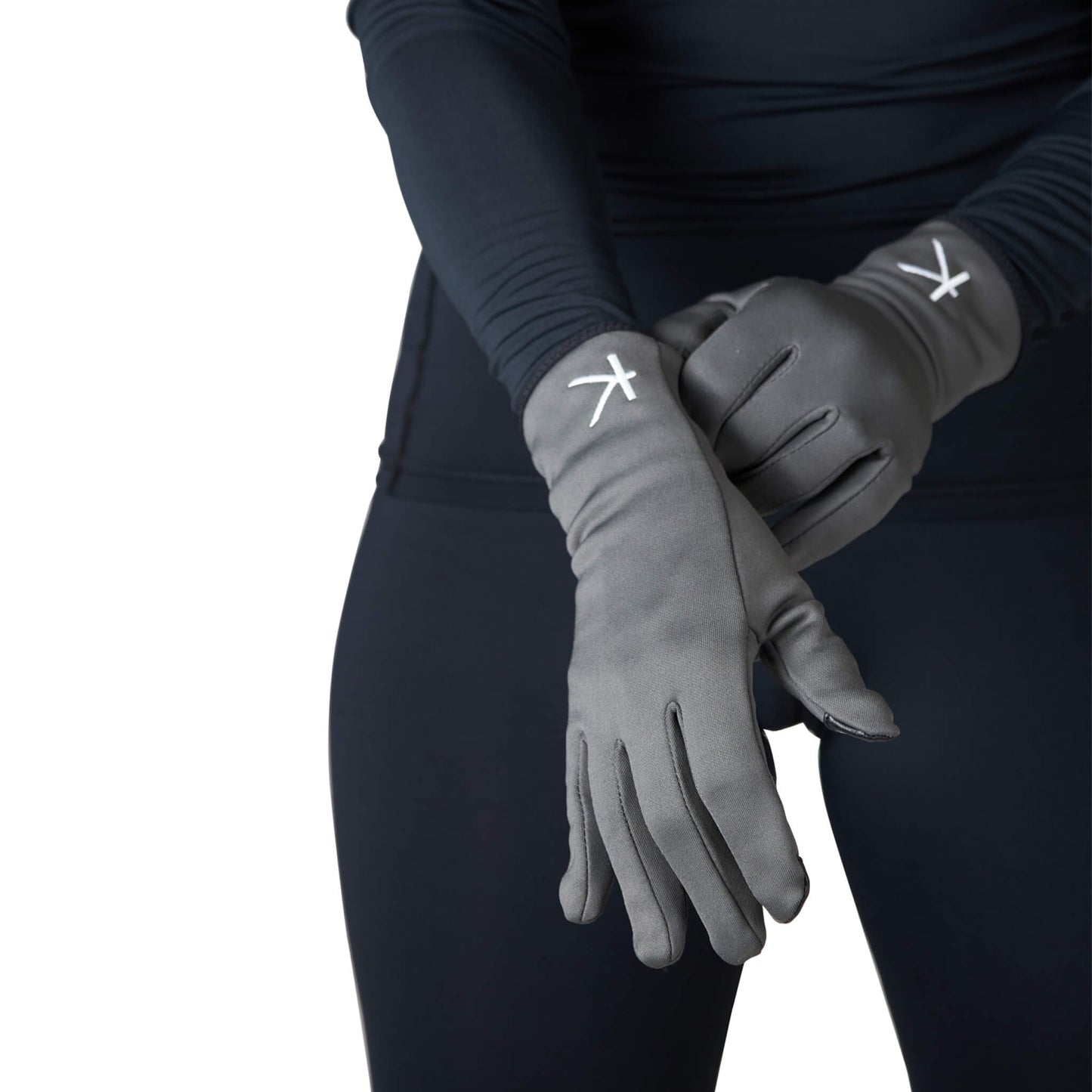 Person wearing gray gloves with a logo on a white background