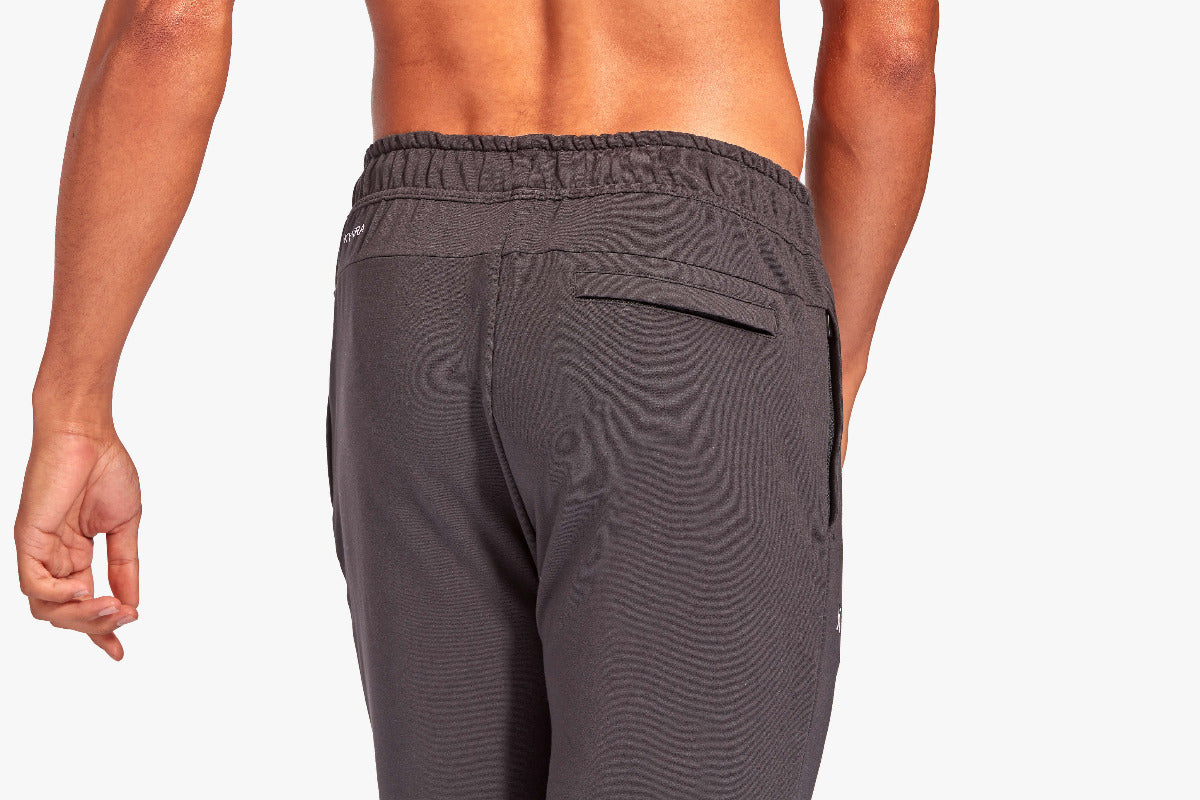 Gray pants worn by a person on a plain background