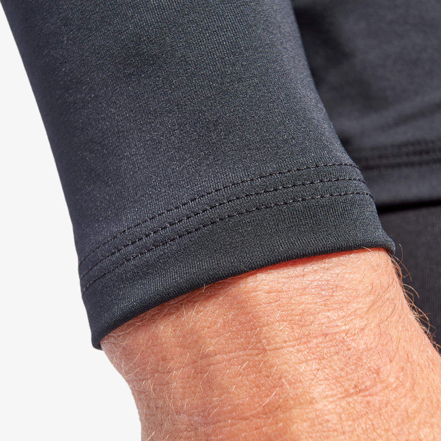 Close-up of a person wearing a dark gray sleeve with a white background