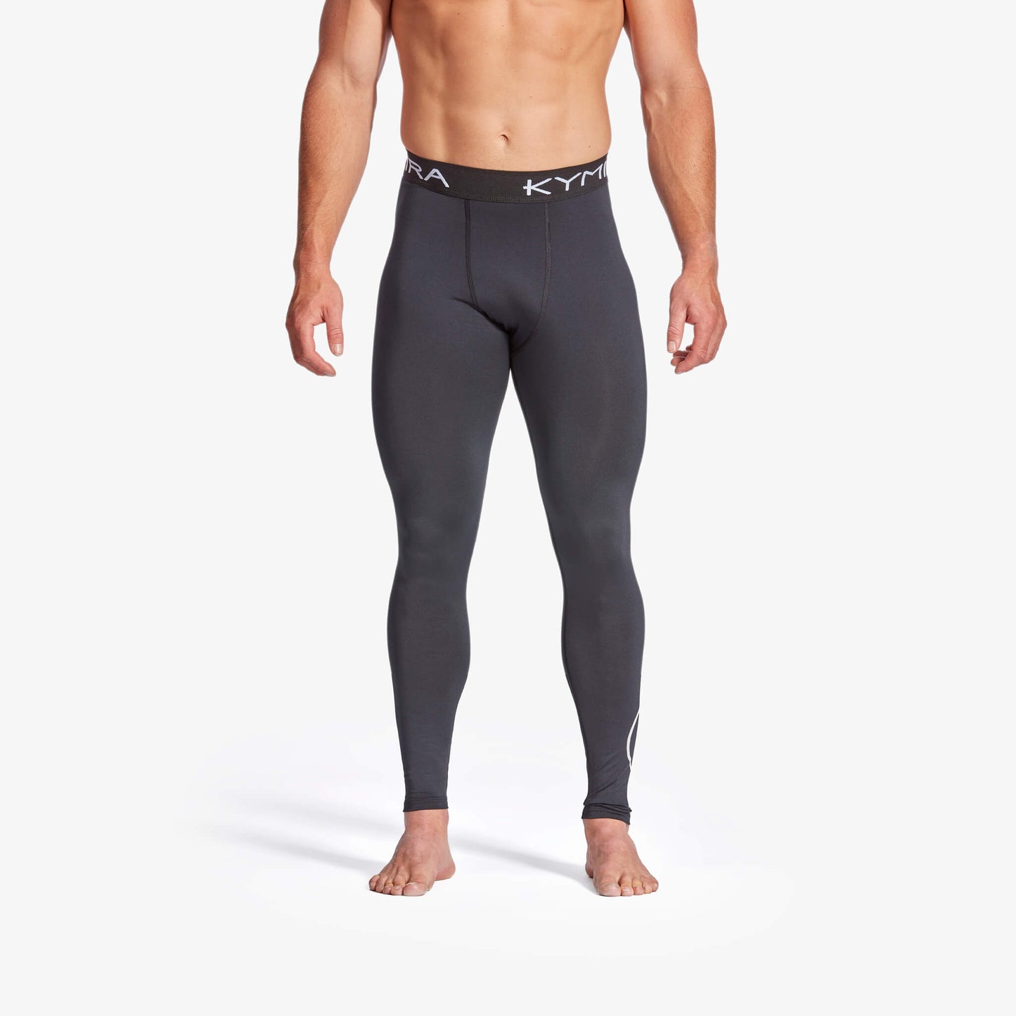 Person wearing black compression leggings with a brand logo on a white background