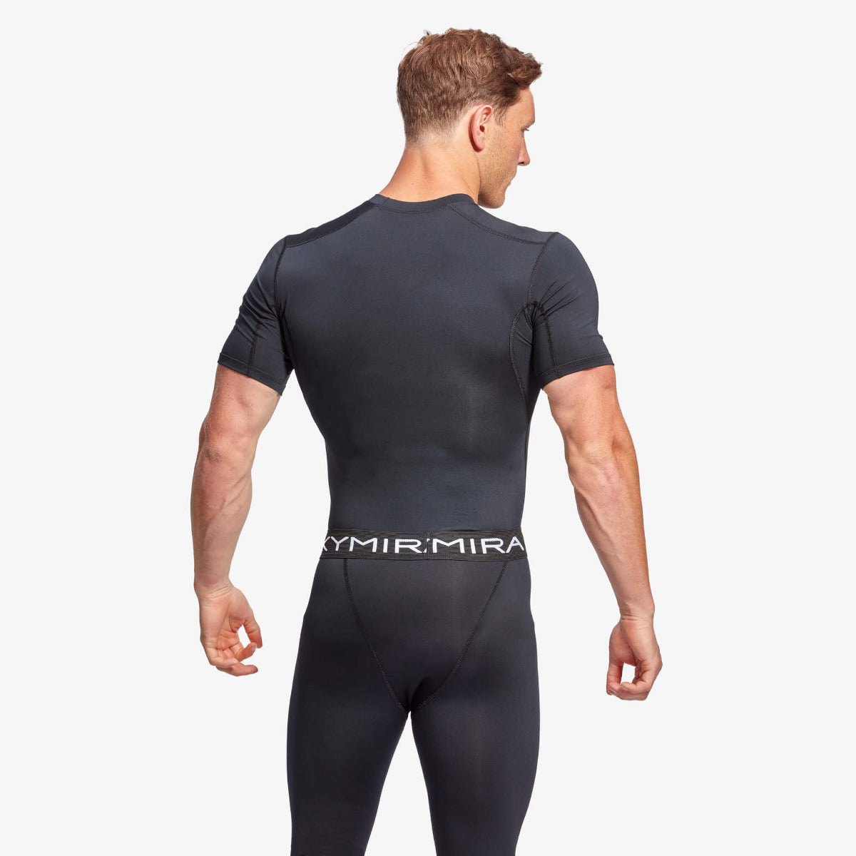 Man wearing a black wetsuit with 'Ymir Mira' branding on a white background