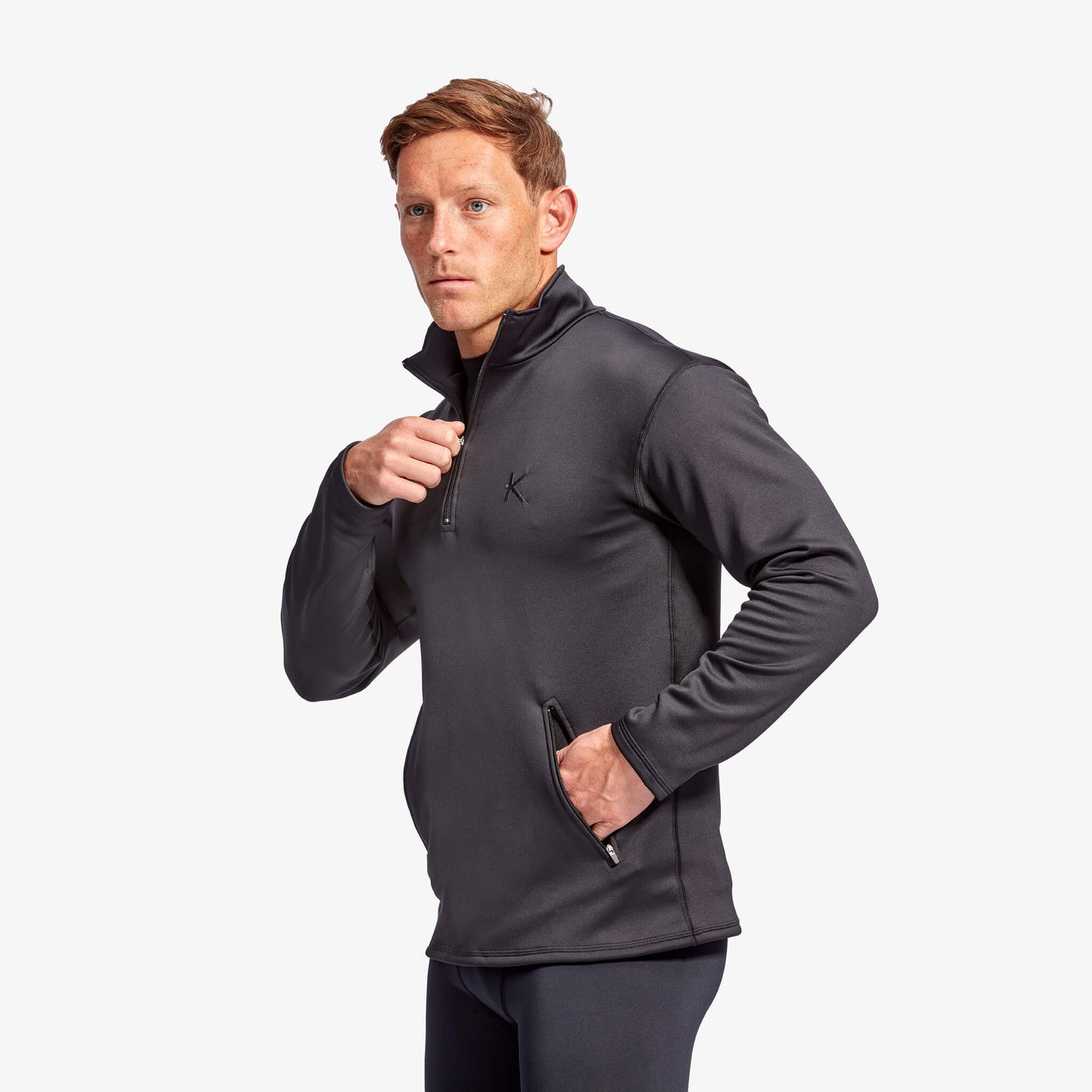 Man wearing a dark gray jacket with a brand logo on a white background