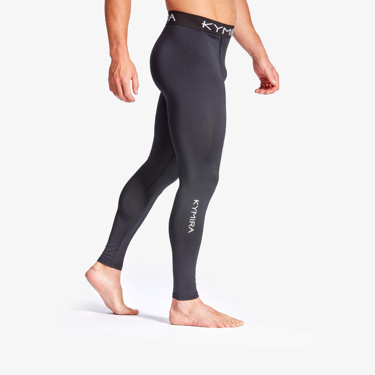 Person wearing black leggings with 'Kymira' branding on a white background