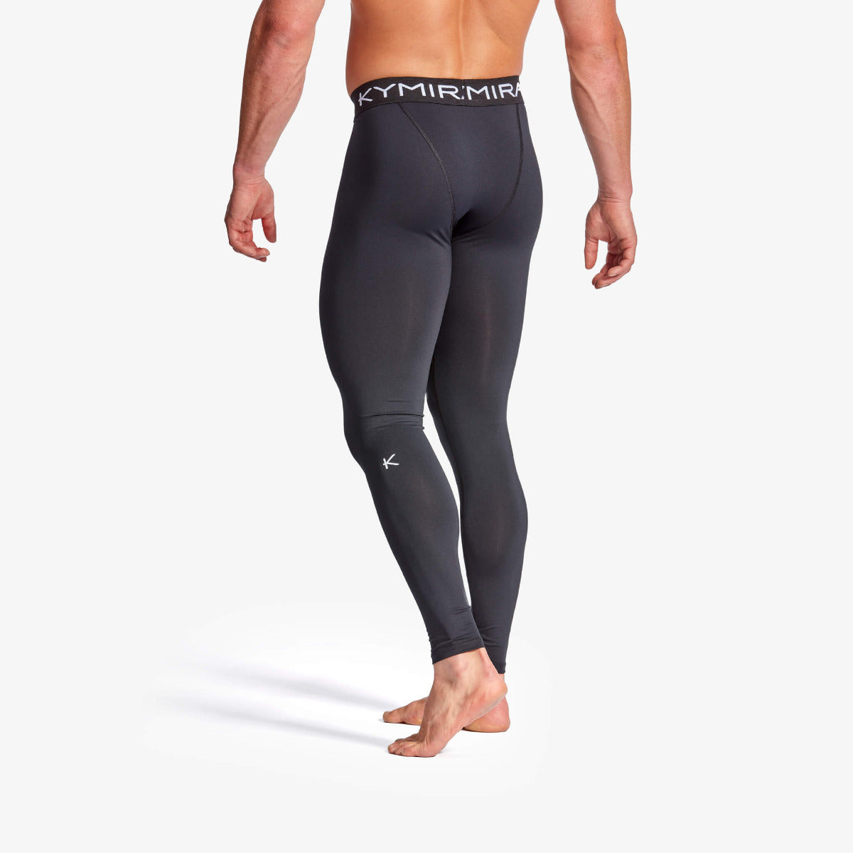 Black compression leggings with visible branding on a white background