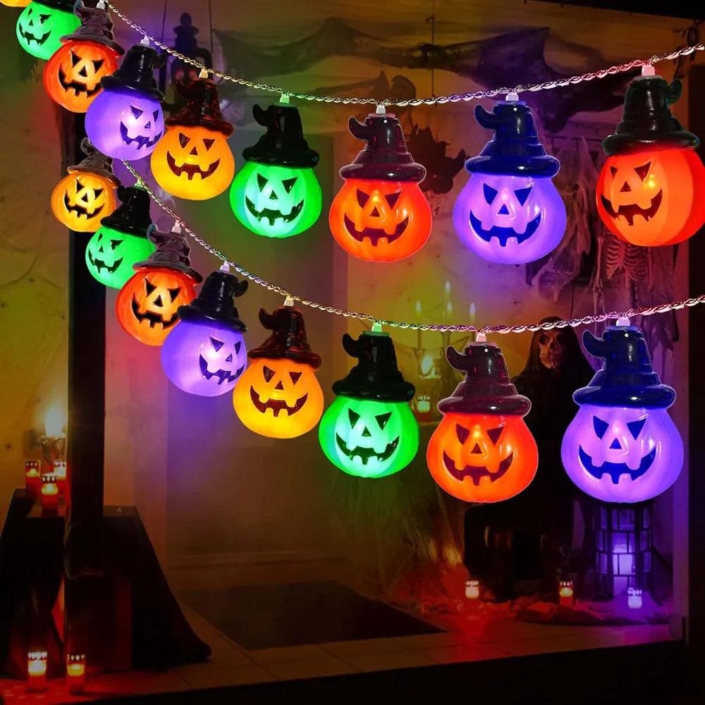 String of colorful Halloween lights shaped like jack-o'-lanterns on a dark background.