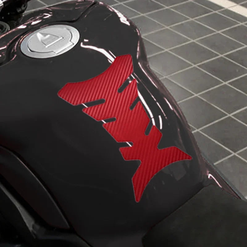 Close-up of a black motorcycle with a red 'FX' logo on a tiled floor background