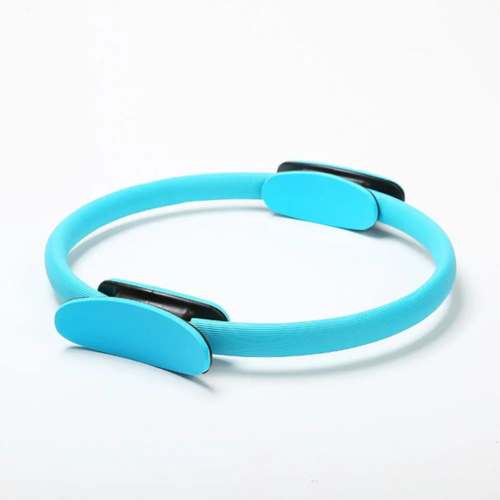Turquoise Pilates ring on a white background
