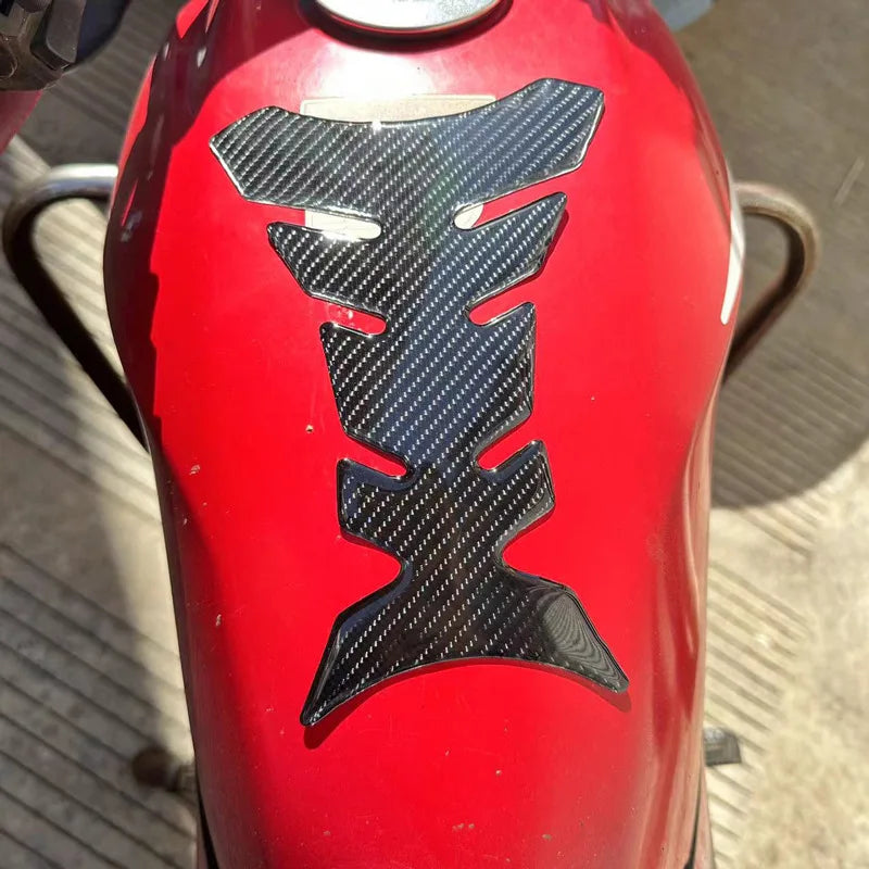 Red motorcycle fuel tank with carbon fiber pattern