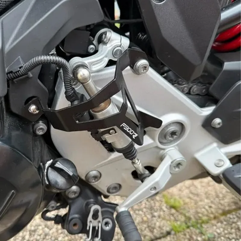 Close-up of a motorcycle's suspension system with visible branding.