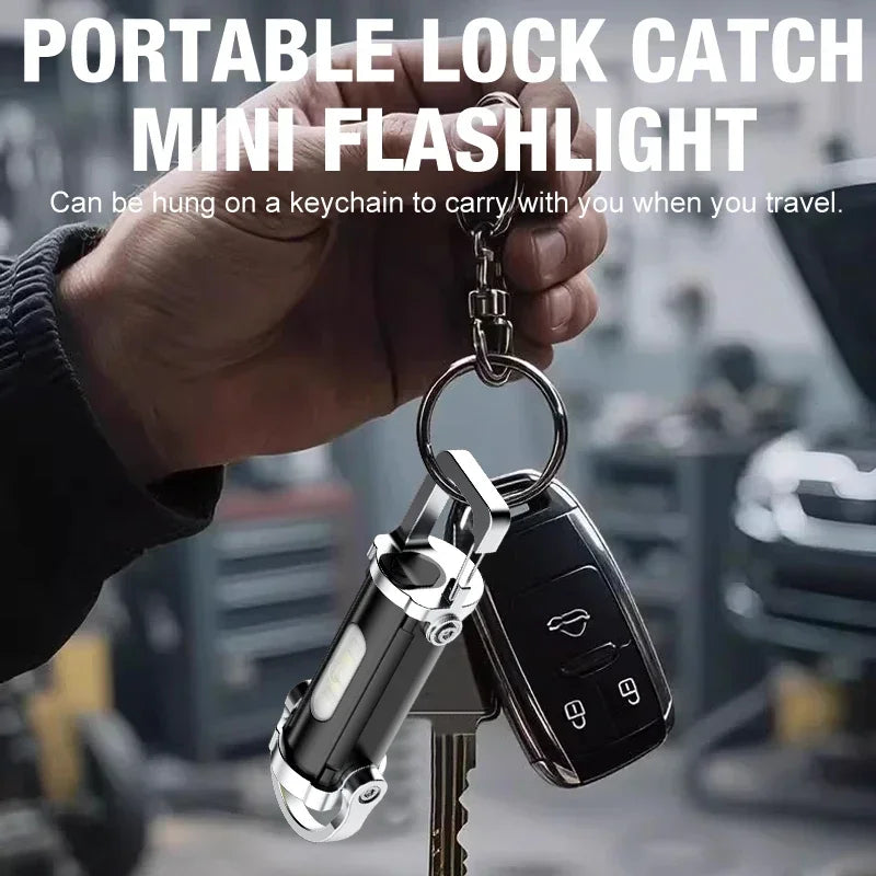 Hand holding a keychain with a portable lock catch mini flashlight attached.