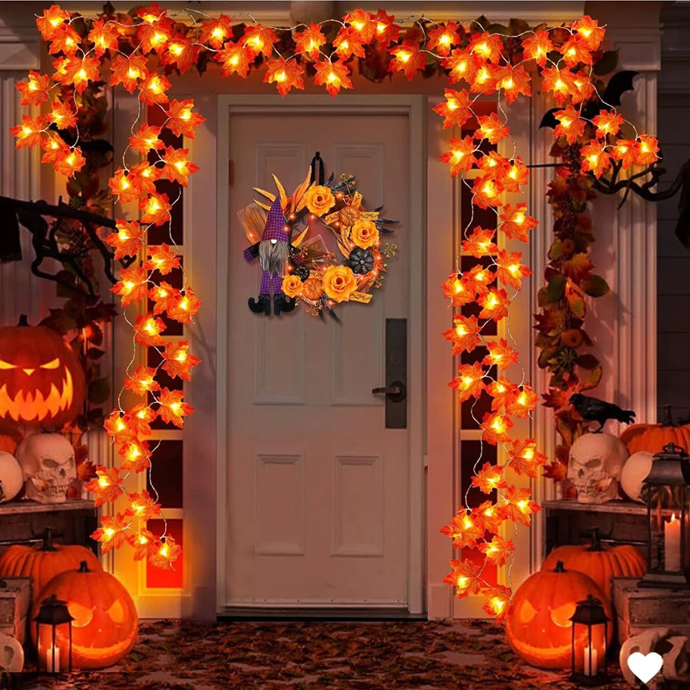 Halloween-themed door decoration with lights, pumpkins, and wreath.
