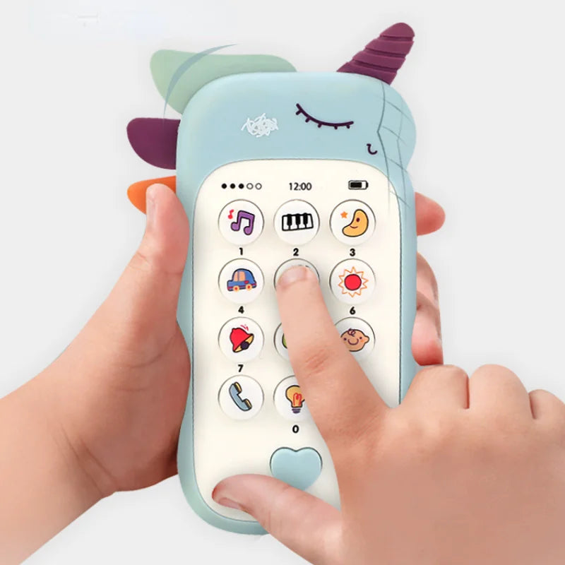 Children's toy phone with cartoon unicorn design held by a hand on a white background