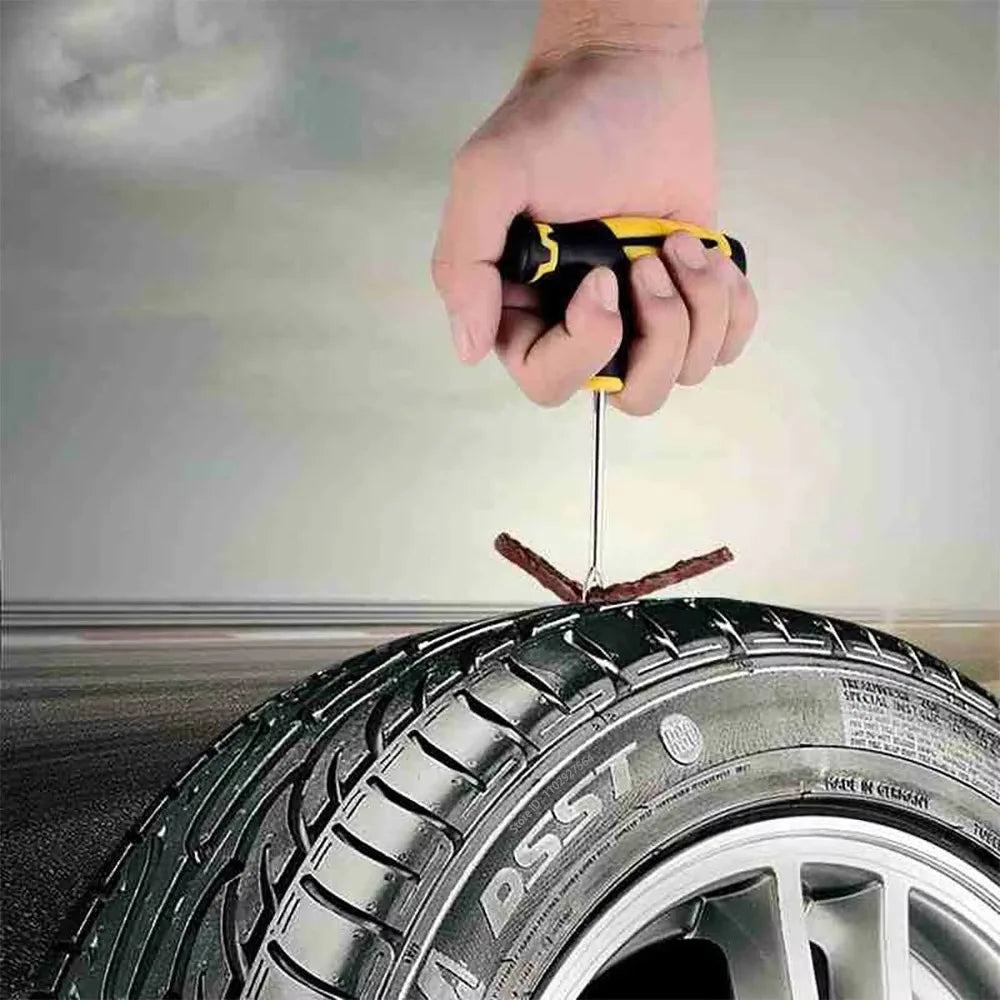 Hand using a tire pressure gauge on a car tire with a blurred background