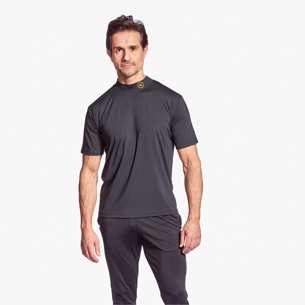 Man wearing a dark gray athletic outfit on a white background