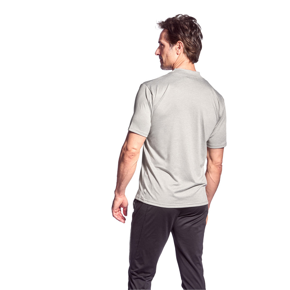 Man wearing a light gray t-shirt and dark gray pants on a white background