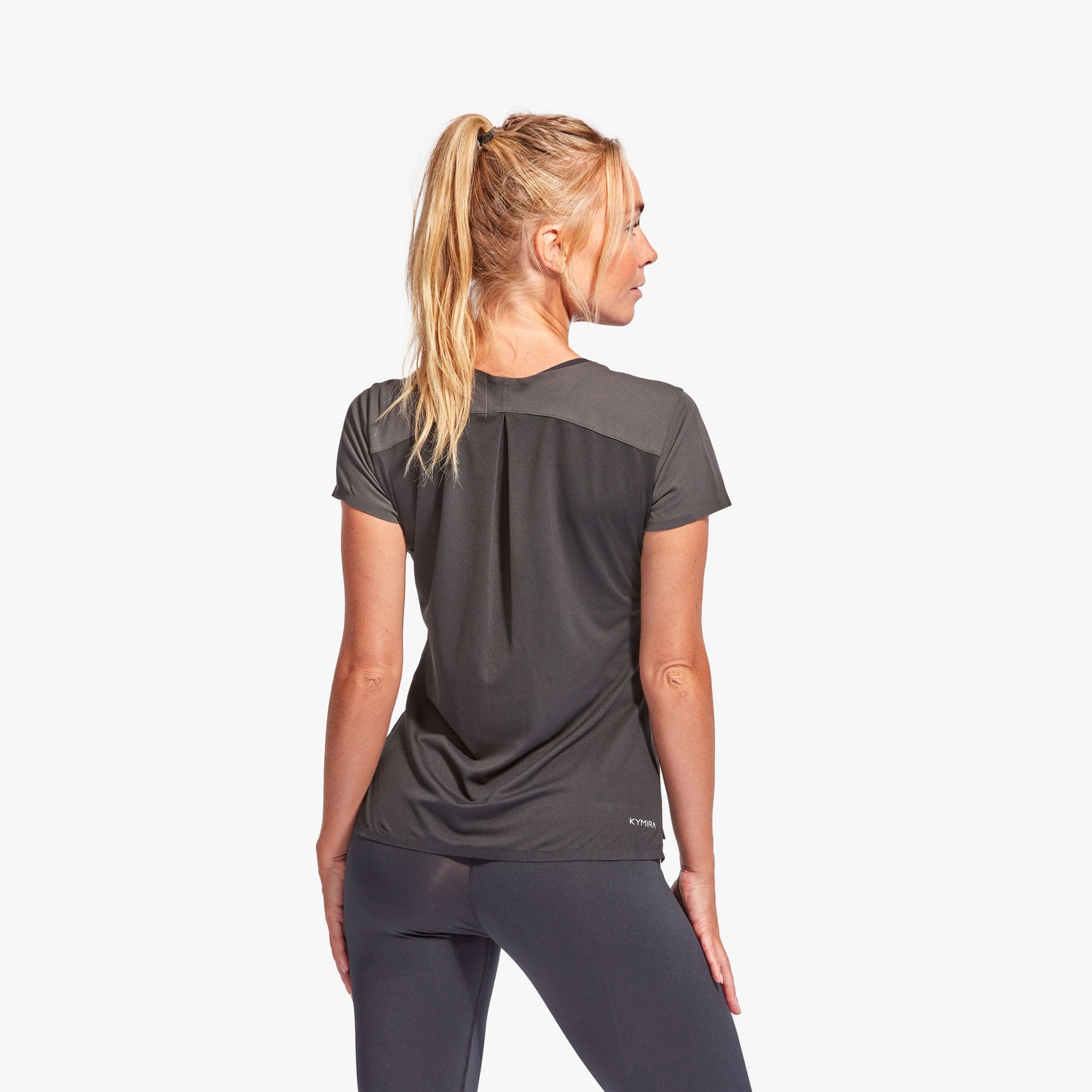 Woman wearing a black athletic outfit on a white background