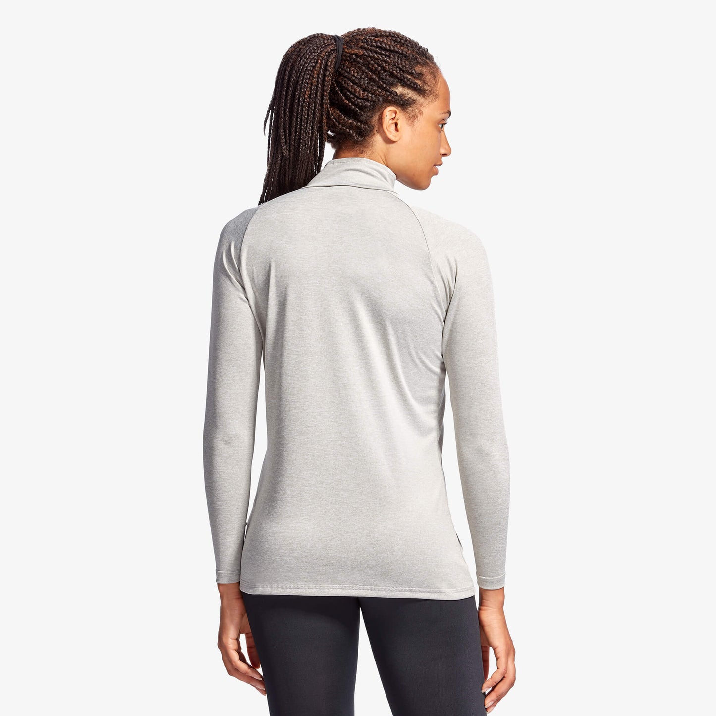 Person wearing a gray long-sleeve athletic top on a white background