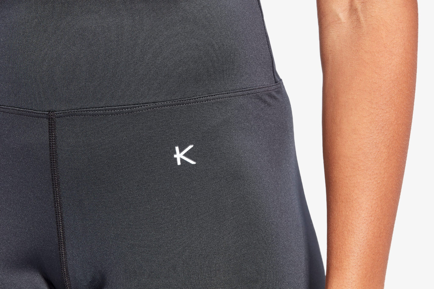 Black athletic outfit with a logo on a plain background