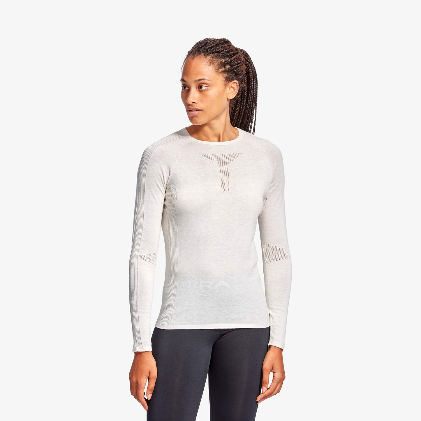 Woman wearing a white long-sleeve athletic shirt on a white background