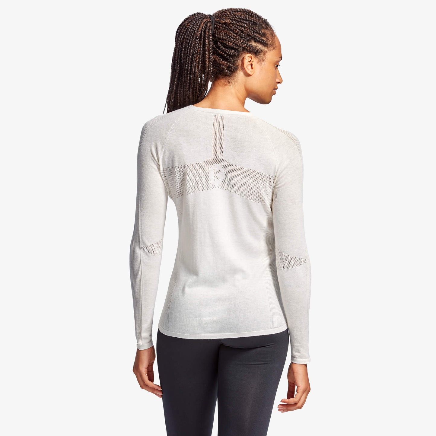 Woman wearing a white long-sleeve athletic shirt on a white background