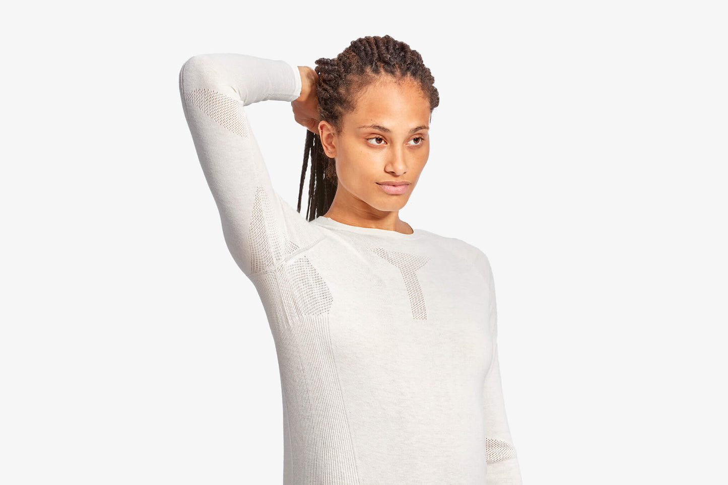 Woman wearing a white long-sleeve shirt against a white background