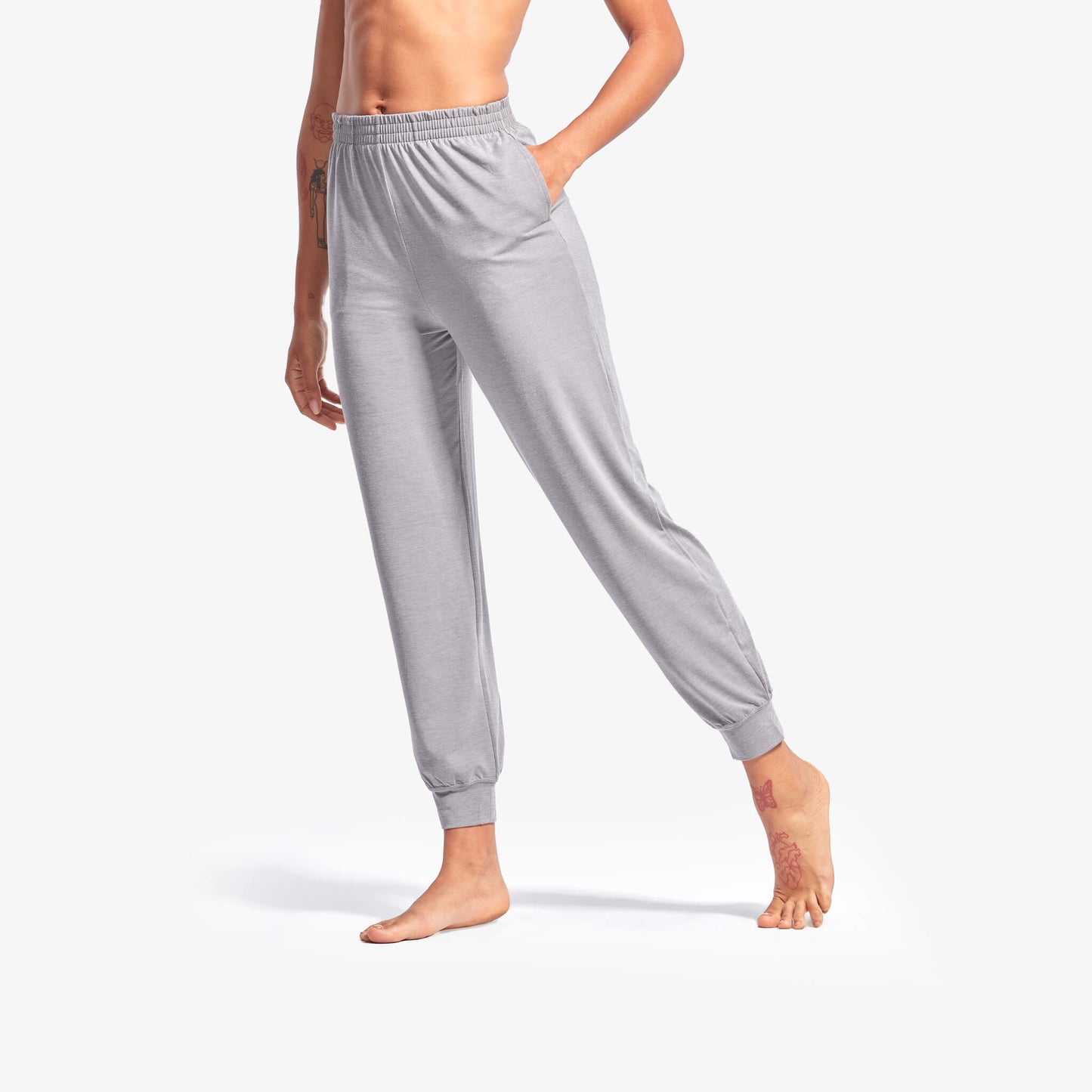 Person wearing gray sweatpants on a white background