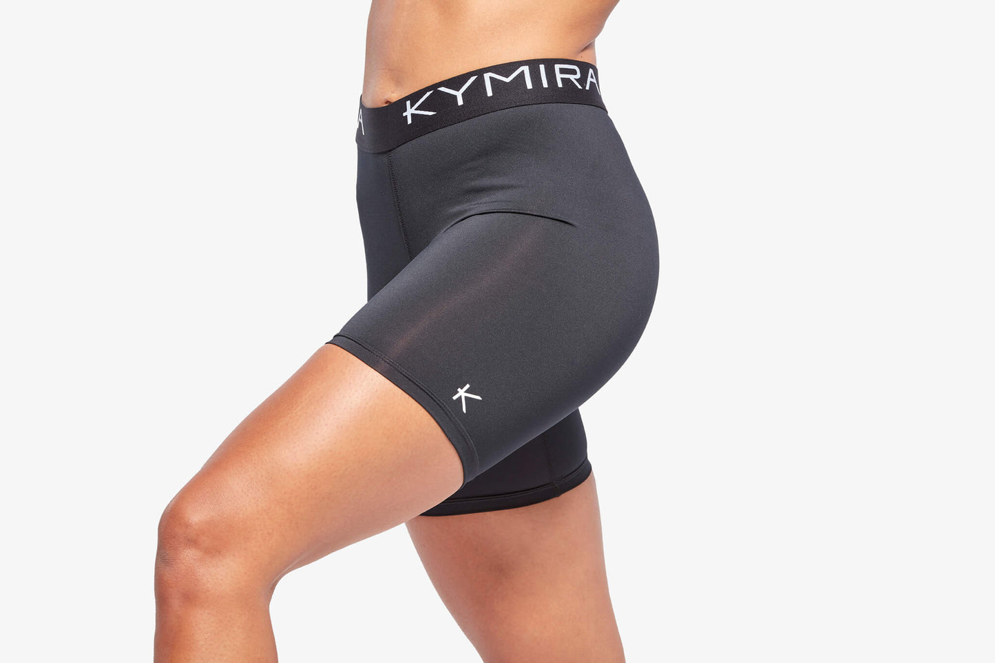Black athletic shorts with 'Kymira' branding on a white background