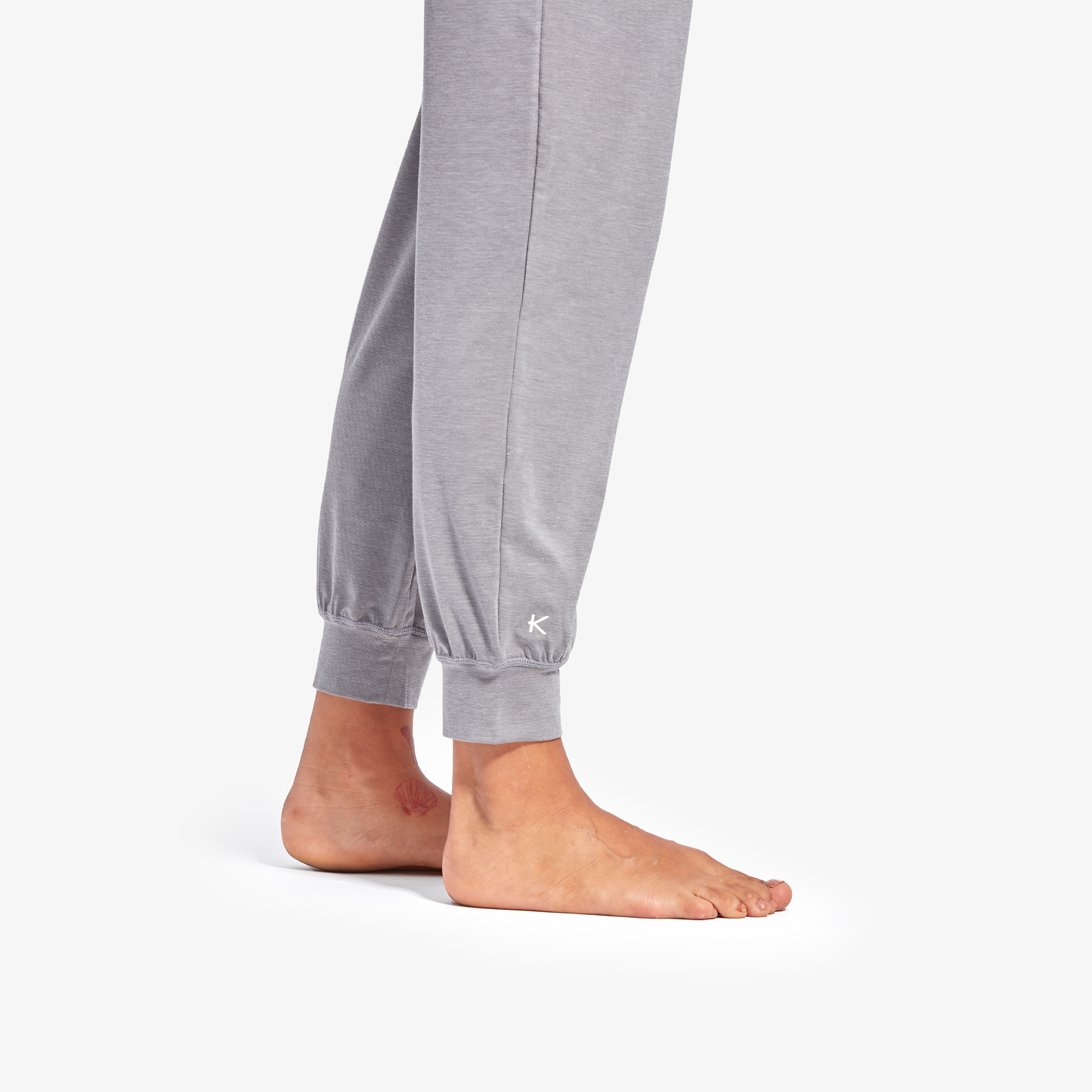 Gray jogger pants with a brand logo on a white background
