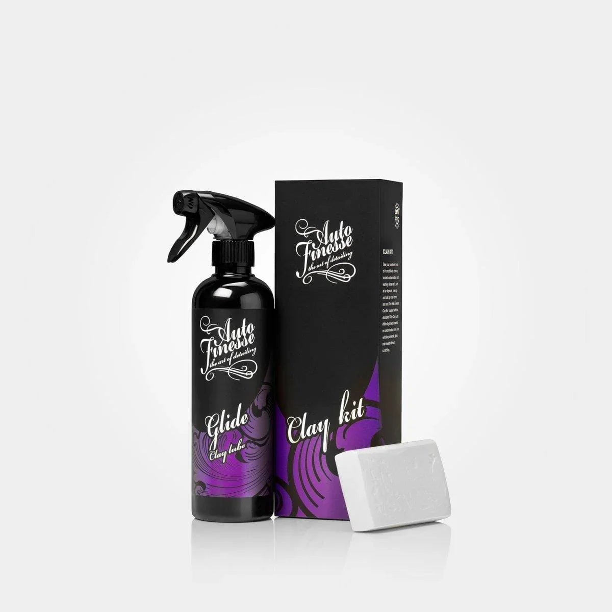 Car care product set with spray bottle, box, and bar of soap on a white background