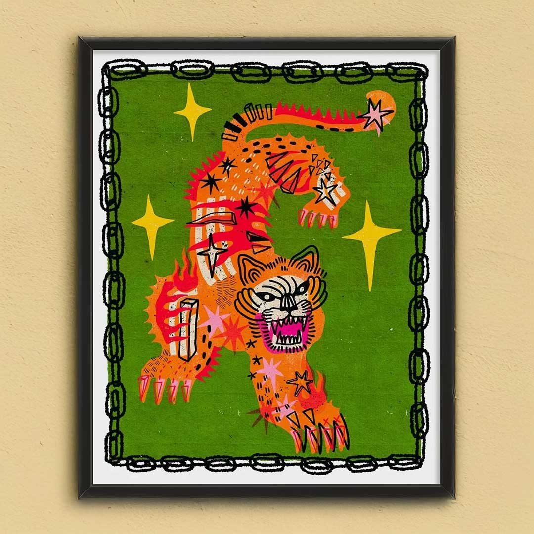 Framed artwork of a colorful tiger design on a green background with stars.