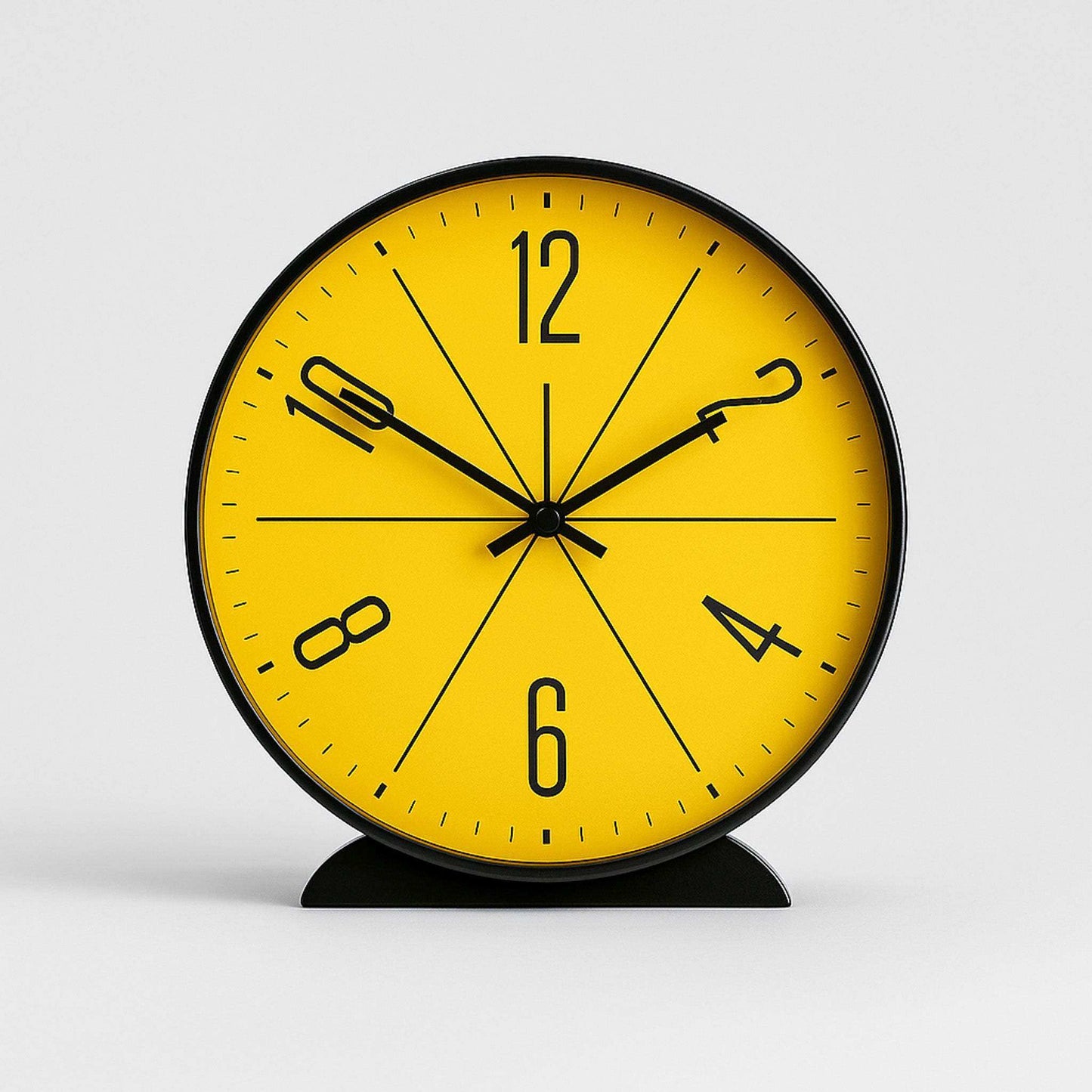 Yellow clock with black numbers and hands on a white background