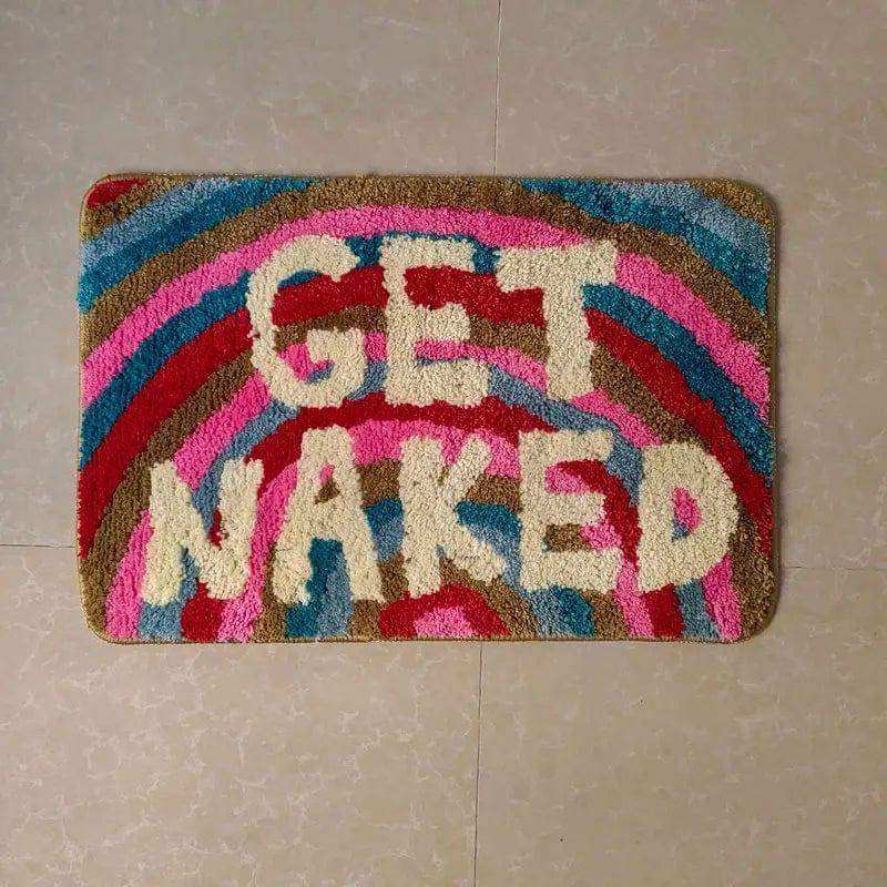 Colorful doormat with 'GET NAKED' text on a tiled floor.