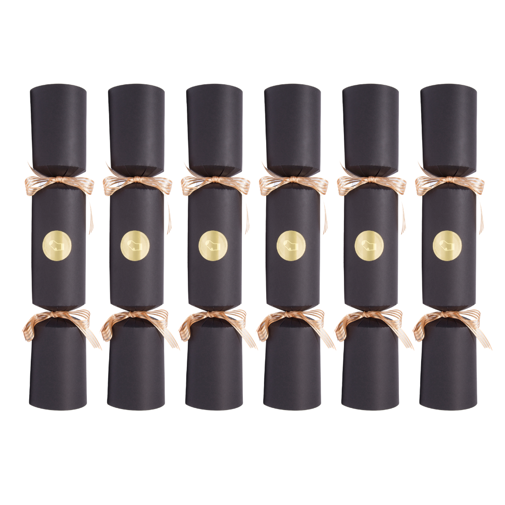 Row of black Christmas crackers with gold centers on a white background