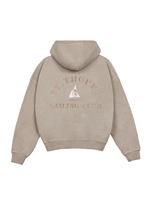 Beige hoodie with 'St. Tropez Sailing Club' text and logo on the back against a white background