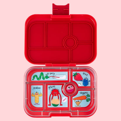 Red lunch box with compartments and cartoon illustrations on a pink background