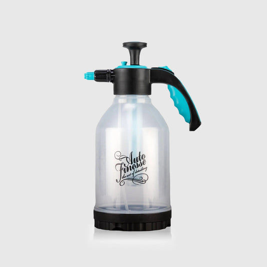 Clear spray bottle with black and blue accents on a light gray background