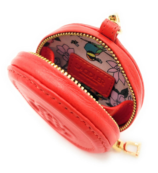 Red round pouch with gold zipper on a white background