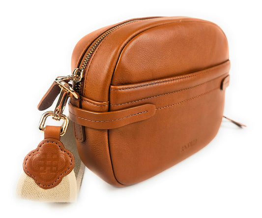 Brown leather bag with a keychain on a white background
