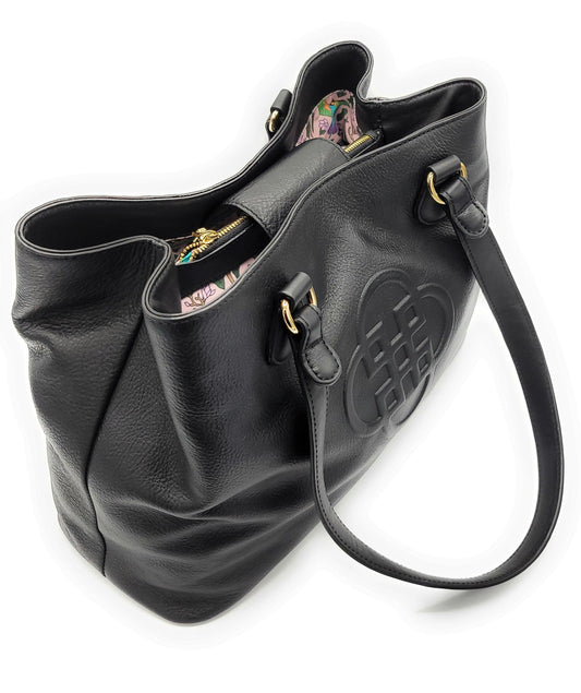 Black leather handbag with floral interior on a white background