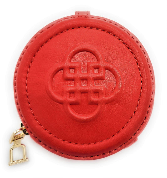 Red round coin purse with a gold zipper on a white background