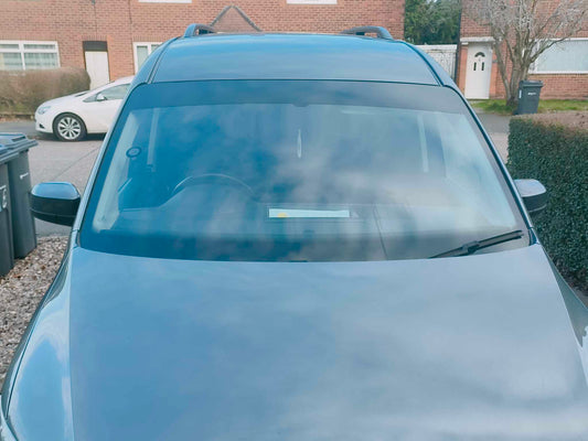 Car with a tinted windshield in a residential area