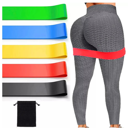 Resistance bands in various colors with a person wearing gray leggings with a red band.