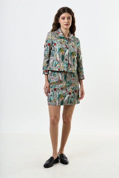 Woman wearing a floral patterned outfit on a white background