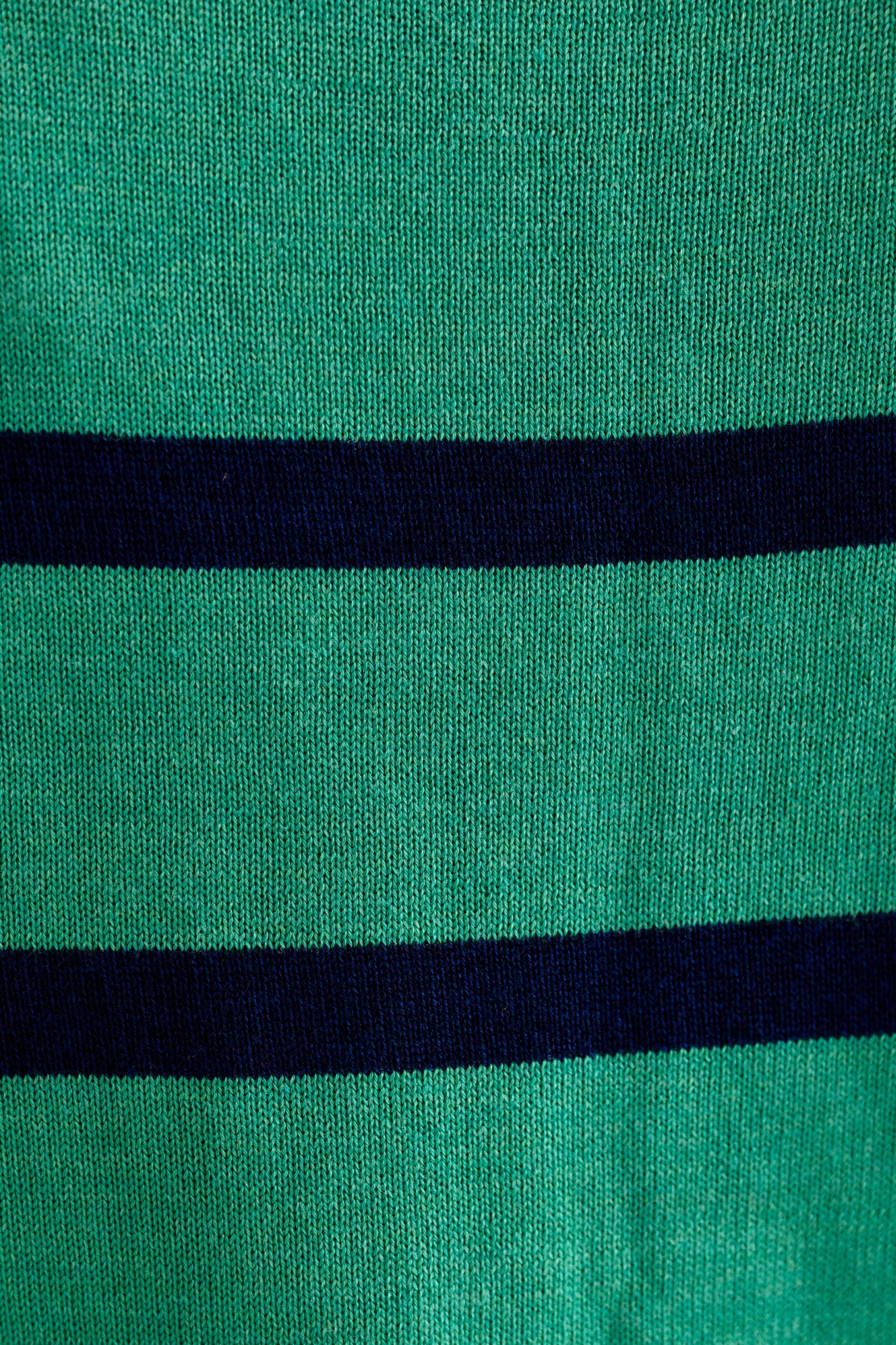 Close-up of a green fabric with two black stripes.