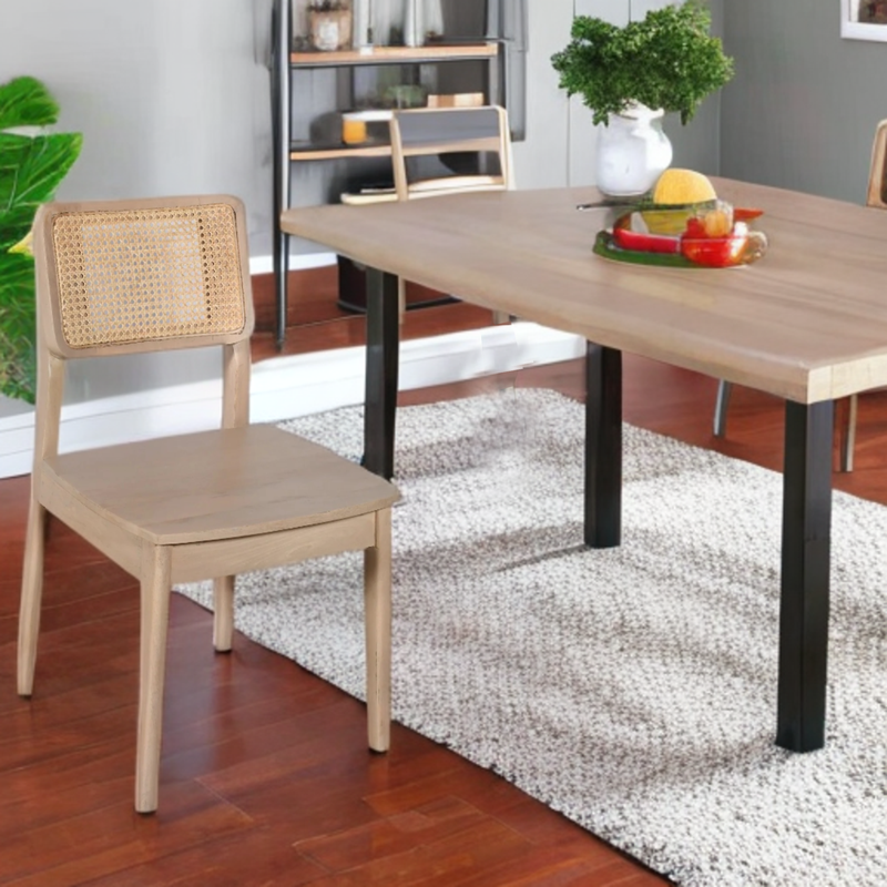 Dining room with wooden table and chair, rug, and decorative items.