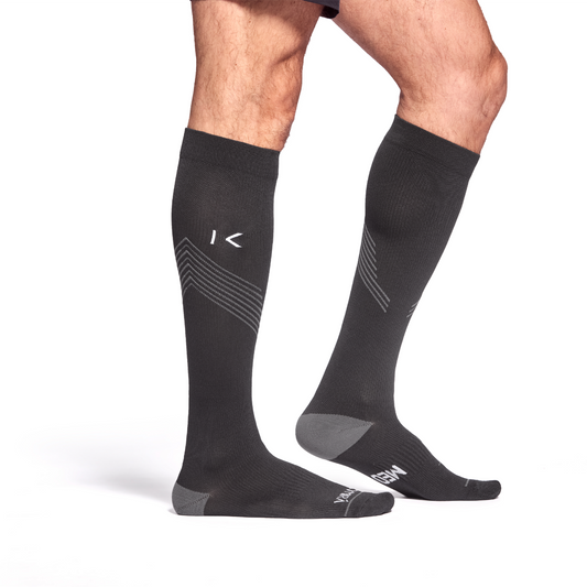 Black knee-high socks with a brand logo on a white background
