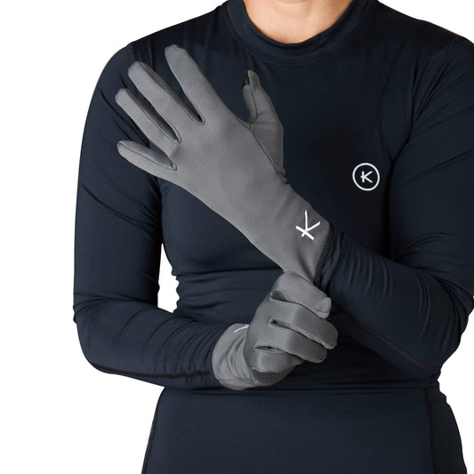 Person wearing gray gloves and a black long-sleeve shirt with a logo on a white background
