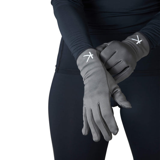 Person wearing gray gloves with a logo on a white background